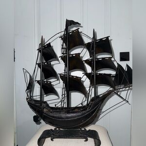 vintage metal ship sculpture, often featuring a black finish
